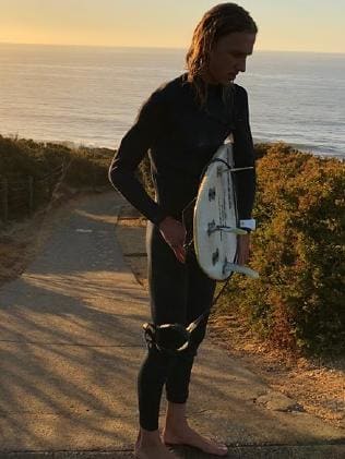 Lachie brown with his surfboard.