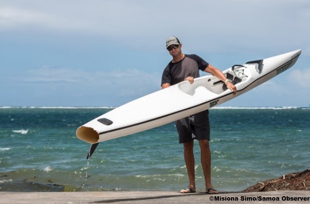 Andrew Wheatley with his shark bitten surfski.