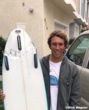 Nick Wapner shows his shark bitten surfboard.