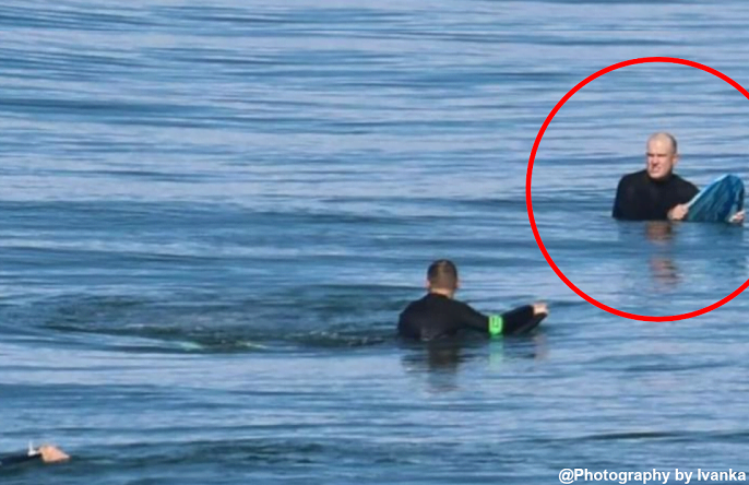 Toby Begg looks toward a disturbance in the water which was a great white which attacked him.